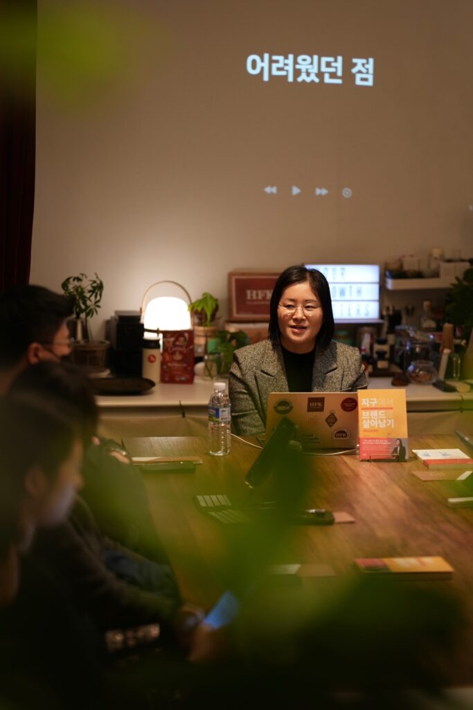 Attorney Sohyun Park speaking at an interview session, screen behind reading 'challenges' in Korean